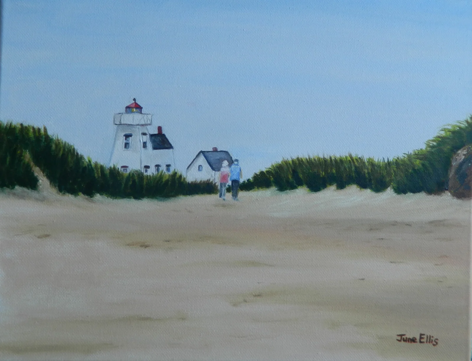 Couple walking to a lighthouse with sandy beach in the foreground